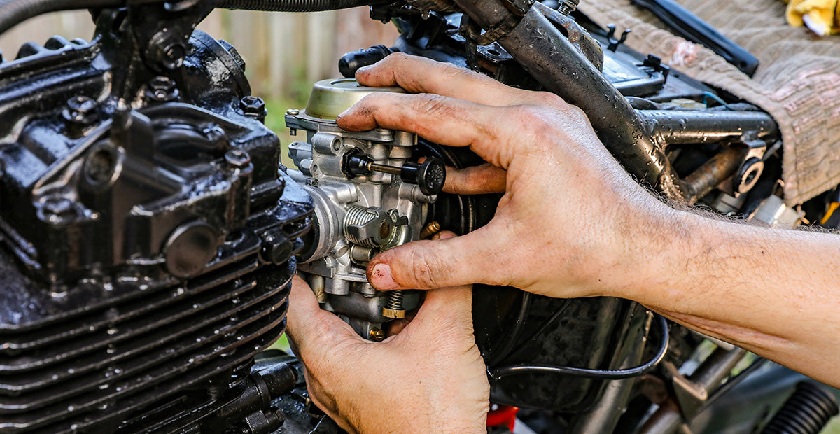 Motorcycle carburetor being installed